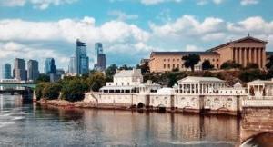 A scenic view of a body of water with buildings located nearby within Philadelphia.