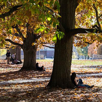 A student sitting by themselves looking pensive.